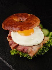 bagel with bacon, tomato, egg and herbs.
