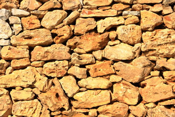 Old yellow brown masonry wall of stones