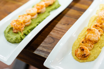 fried prawns on sweet potato puree.