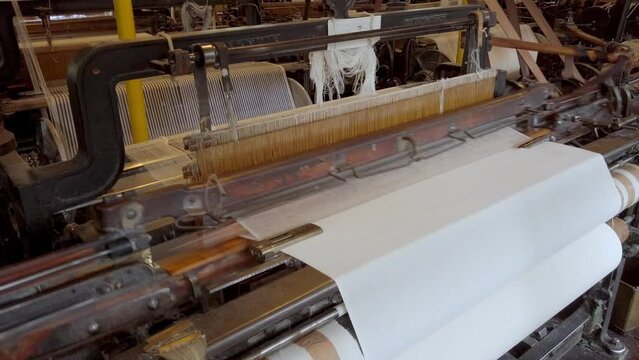A cotton loom at a working textile mill, with audio. Powered by a water wheel.