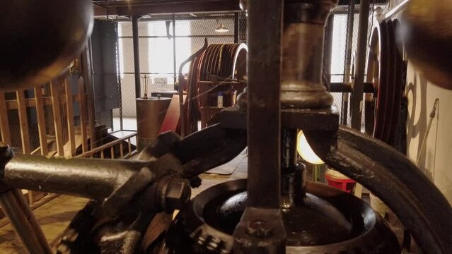 A working textile mill.  Spherical speed regualtors, spinning.