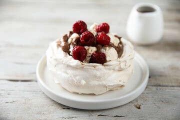 Fototapeta na wymiar Homemade Pavlova dessert with raspberry and chocolate