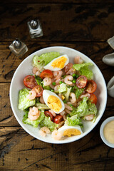 Homemade salad with shrimps and eggs