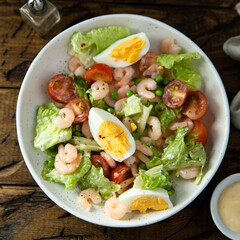 Homemade salad with shrimps and eggs