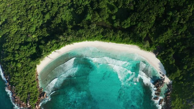 Aerial flat slider over Anse Cocos beach with white sand, La Digue