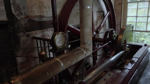 A horizontal steam engine at a working cotton mill.  Overview of operation