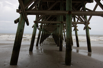 Under the pier on a cloudy day at the beach