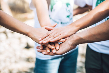 Close up of people volunteer teamwork putting hands together,Stack of hands,Unity and teamwork on world environment day.