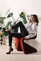 beautiful girl in a white shirt is sitting