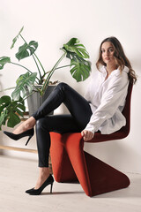 beautiful girl in a white shirt is sitting