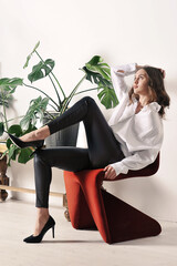 beautiful girl in a white shirt is sitting