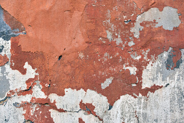 Old wall texture with cracked peeling paint. Abstract grunge backdrop
