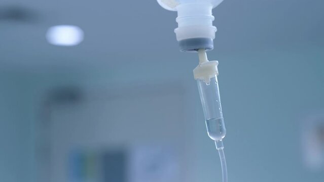 Dripping saline, Dripping medical perfusion close up equipment in clinic background, Medical equipment, Saline Solution IV Drip Fluid for Infusion in Hospital. Intravenous drip in operation room.