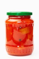 Lecho canned in glass jar on white