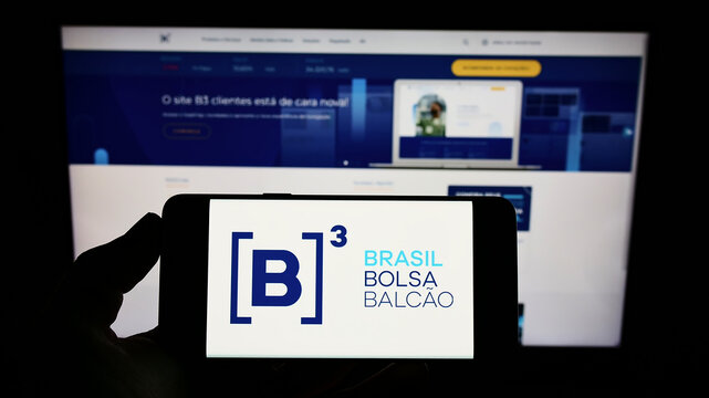 Stuttgart, Germany - 03-12-2022: Person holding cellphone with logo of financial company B3 S.A. - Brasil, Bolsa, Balcao on screen in front of webpage. Focus on phone display.