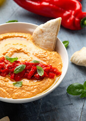 Roasted red pepper hummus with pita bread. Healthy food