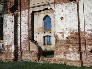 Fototapeta na wymiar Destroyed Lutheran church of 19th century against blue sky in former canton of Schaefer in Saratov region. Outdoor.