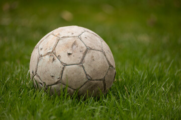 old soccer ball on grass