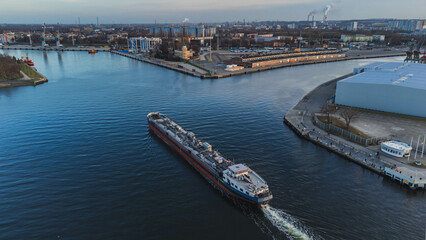 The lighthouse in Nowy Port, the port canal and the ship entering the port. Gdansk.