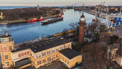 The lighthouse in Nowy Port, the port canal and the ship entering the port. Gdansk.
