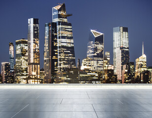 Empty concrete rooftop on the background of a beautiful blurry New York city skyline at evening,...