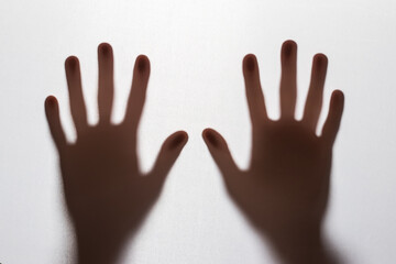 Abstract blur hands silhouettes behind glass foreground