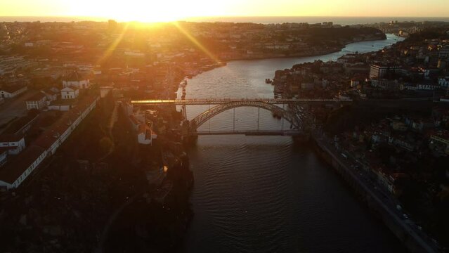 Dron view of Duero river with the bridge and the districts of Porto at sunset