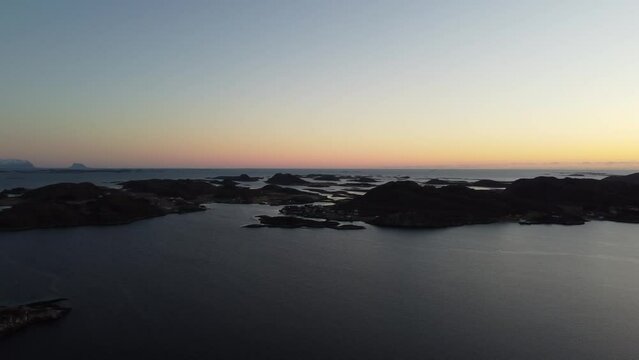 sunset over the sea and archipelago aerial overview video from heroy island in Nordland