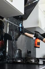 Professional Cleaning service company employee in rubber gloves remove dirt from work top using soft duster in kitchen, disinfection and sterile