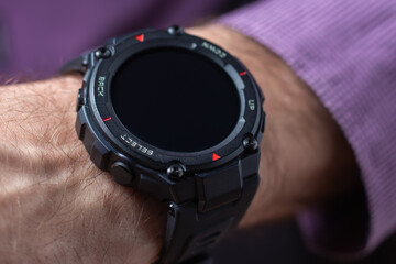 Hand of man wearing trendy smart watch. Modern gadget that lets you always stay connected to...