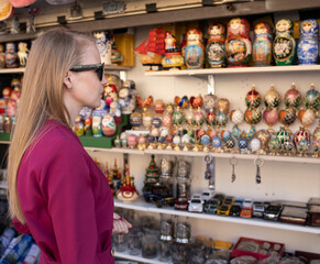 07.15.2021 Russia, St. Petersburg, central square. A beautiful girl guide, blonde, in a dress, on...