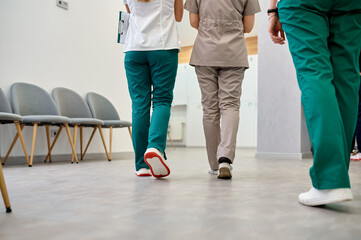 Hospital corridor with walking doctors cropped shot
