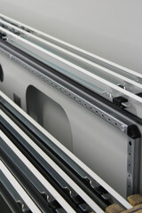 Obraz premium Disassembled metal structures, metal doors lie sideways and form geometric lines that go into perspective.