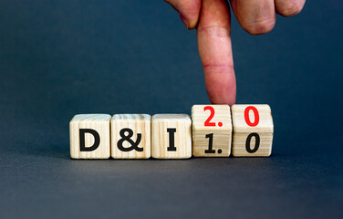 Diversity and inclusion 2.0 symbol. Businessman turns cubes and changes words Diversity and Inclusion 1.0 to 2.0. Beautiful grey background. Business Diversity and inclusion 2.0 concept. Copy space.