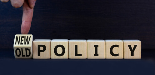 New or old policy symbol. Turned wooden cubes changed concept words Old policy to New policy....