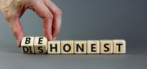 Be honest or dishonest symbol. Businessman turns cubes and changes concept words Dishonest to Be honest. Beautiful grey table grey background. Business be honest or dishonest concept. Copy space.
