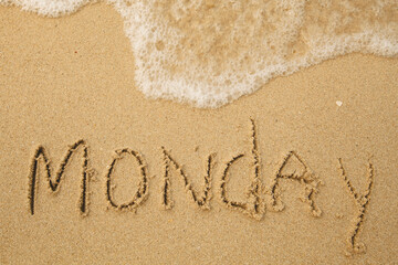 Monday - handwritten on the soft beach sand.