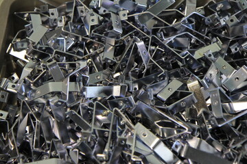 A lot of metal staples are in a box in the warehouse. Production concept.