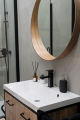 Large mirror over vessel sink in stylish bathroom interior