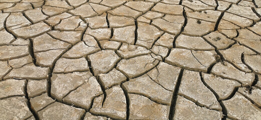 Dry riverbed, with arid and cracked soil because of drought, due to climate change