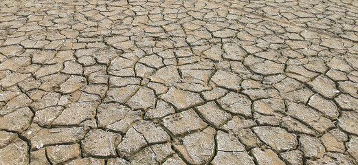 Dry riverbed, with arid and cracked soil because of drought, due to climate change