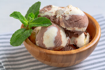 Chocolate-vanilla ice cream in a wooden bowl.