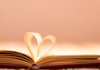 Open book with leaves forming a heart. Love concept.