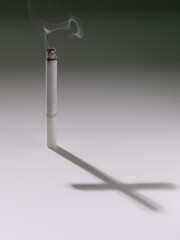 Fototapeta na wymiar Cigarette with a cross as a shadow