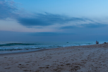 Fototapeta na wymiar Beach Fishing at Dawn on an Overcast Day