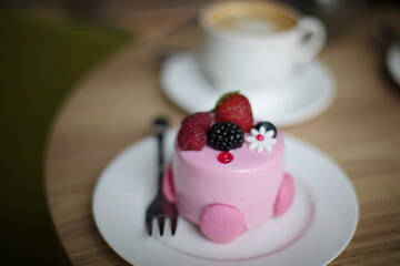 Pink desserts with berries on a table