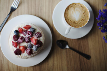 Pavlova dessert with a cup of coffee. 