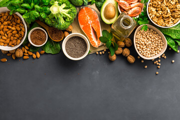 Fototapeta Food sources of omega 3 on dark background with copy space top view. Foods high in fatty acids including vegetables, seafood, nut and seeds. Health food fitness obraz