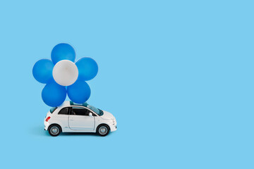 Toy car with Blue and white balloons. Concept of Independence Day of Israel.