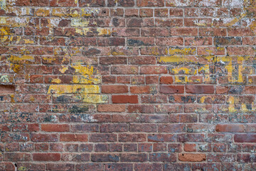 grunge brick wall background texture from old industrial building with the remains of paint